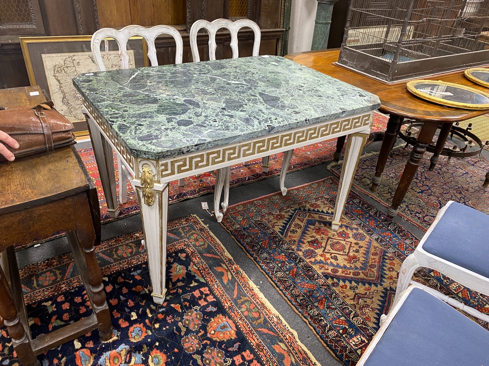 A William Kent style cream and gilt painted side table, with a green variegated marble top, width 118cm, depth 85cm, height 77cm